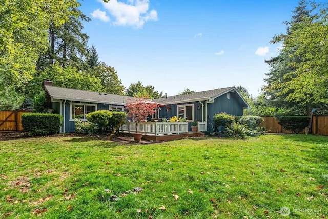 rear view of house with a wooden deck and a chimney