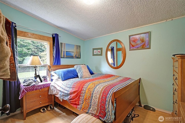 472 Iris Ln, Camano Island, WA 98282 - bedroom with a textured ceiling, wood finished floors, crown molding, and vaulted ceiling