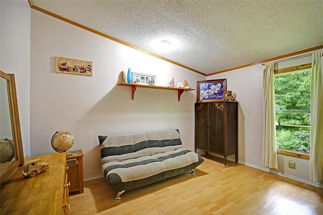472 Iris Ln, Camano Island, WA 98282 - sitting room featuring ornamental molding, a textured ceiling, vaulted ceiling, wood finished floors, and a textured wall