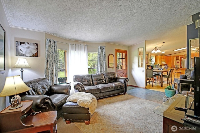 472 Iris Ln, Camano Island, WA 98282 - living room with a chandelier, tile patterned floors, a textured ceiling, and ornamental molding