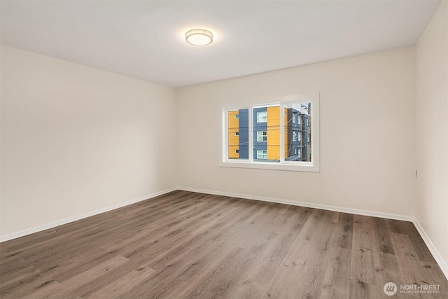 816 N 43rd St, Seattle, WA 98103 - empty room featuring wood finished floors and baseboards