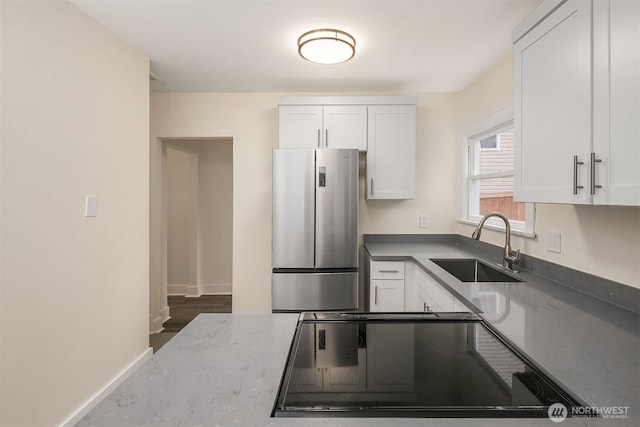 816 N 43rd St, Seattle, WA 98103 - kitchen featuring freestanding refrigerator, a sink, and white cabinets