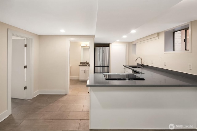 816 N 43rd St, Seattle, WA 98103 - kitchen featuring freestanding refrigerator, a sink, dark countertops, recessed lighting, and light tile patterned floors