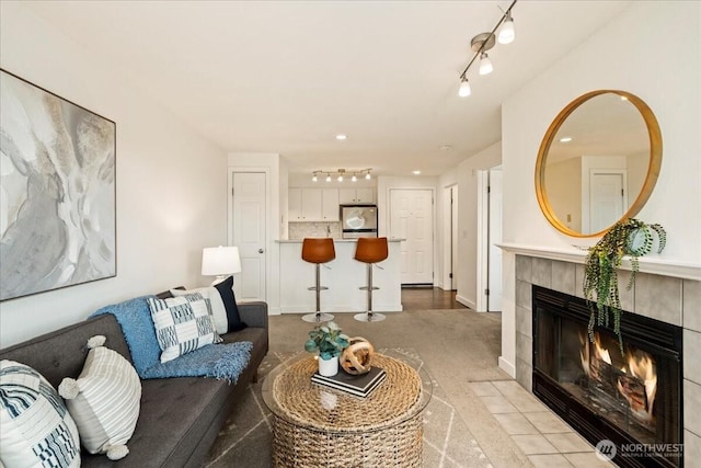 9200 Greenwood Ave N Unit 511, Seattle, WA 98103 - living area with rail lighting, a fireplace, and light colored carpet