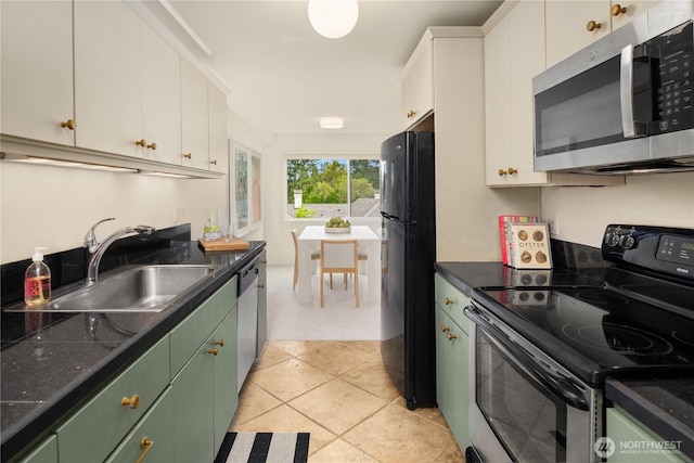 2501 Canterbury Ln E Unit 318, Seattle, WA 98112 - kitchen with appliances with stainless steel finishes, a sink, green cabinetry, white cabinetry, and light tile patterned flooring