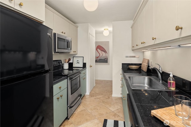 2501 Canterbury Ln E Unit 318, Seattle, WA 98112 - kitchen featuring stainless steel appliances, a sink, dark countertops, white cabinets, and baseboards