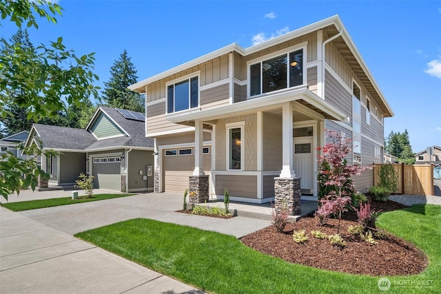 2880 75th Ave SW Lot 62, Tumwater, WA 98512 - view of front of property featuring concrete driveway, a porch, board and batten siding, roof mounted solar panels, and an attached garage