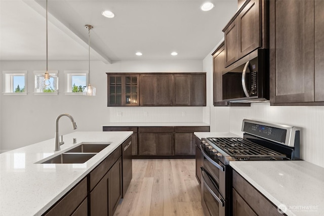 2880 75th Ave SW Lot 62, Tumwater, WA 98512 - kitchen with stainless steel appliances, light wood finished floors, backsplash, dark brown cabinetry, and recessed lighting