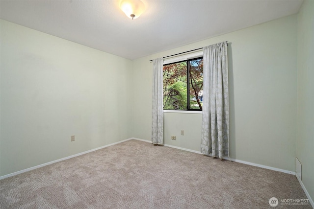 unfurnished room with carpet flooring and baseboards