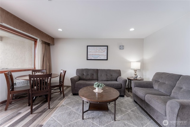 living area with wood finished floors and recessed lighting