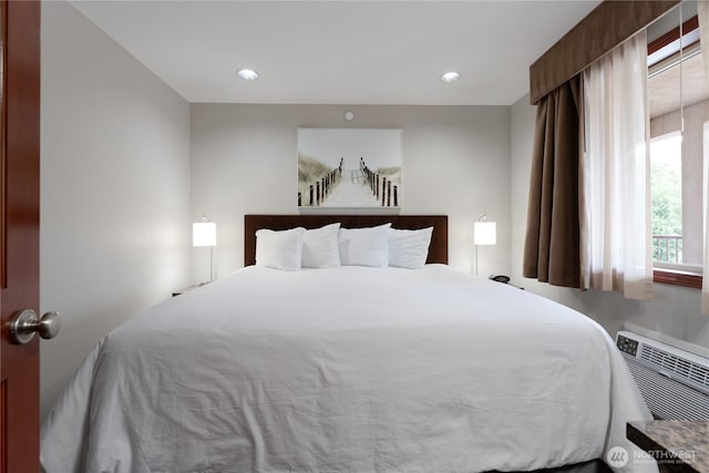 bedroom featuring a wall mounted AC and recessed lighting