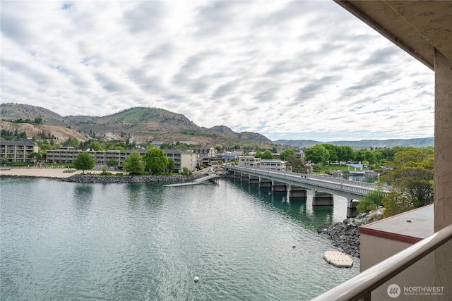 water view featuring a mountainous background and a notable bridge