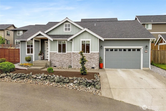 6068 Monument Dr, Ferndale, WA 98248 - craftsman-style house with fence, board and batten siding, concrete driveway, a garage, and roof with shingles
