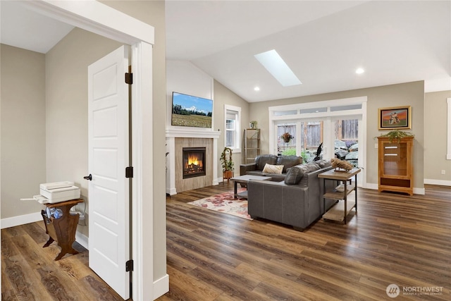 6068 Monument Dr, Ferndale, WA 98248 - living area featuring a skylight, a tile fireplace, dark wood-style floors, baseboards, and vaulted ceiling