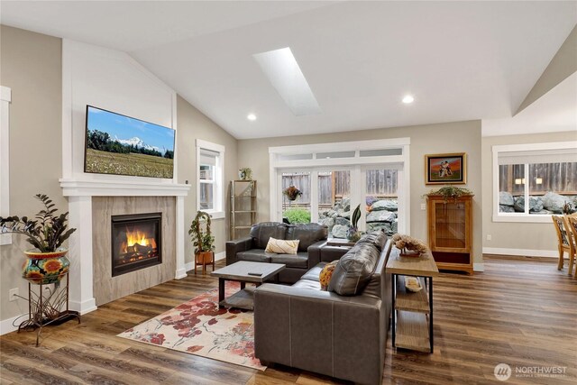 6068 Monument Dr, Ferndale, WA 98248 - living area featuring lofted ceiling, a tile fireplace, wood finished floors, plenty of natural light, and baseboards