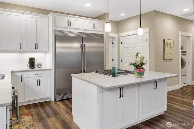 6068 Monument Dr, Ferndale, WA 98248 - kitchen with appliances with stainless steel finishes, white cabinets, dark wood-style flooring, light countertops, and recessed lighting