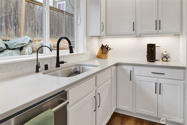 6068 Monument Dr, Ferndale, WA 98248 - kitchen with stainless steel dishwasher, a sink, tasteful backsplash, and light countertops
