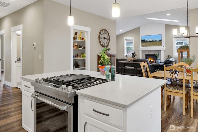 6068 Monument Dr, Ferndale, WA 98248 - kitchen featuring stainless steel gas range oven, dark wood finished floors, healthy amount of natural light, lofted ceiling, and recessed lighting