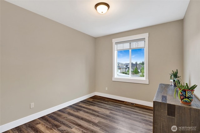 6068 Monument Dr, Ferndale, WA 98248 - spare room featuring baseboards and dark wood-type flooring