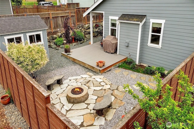 6068 Monument Dr, Ferndale, WA 98248 - view of patio / terrace with a fire pit, a deck, a fenced backyard, an outdoor structure, and area for grilling