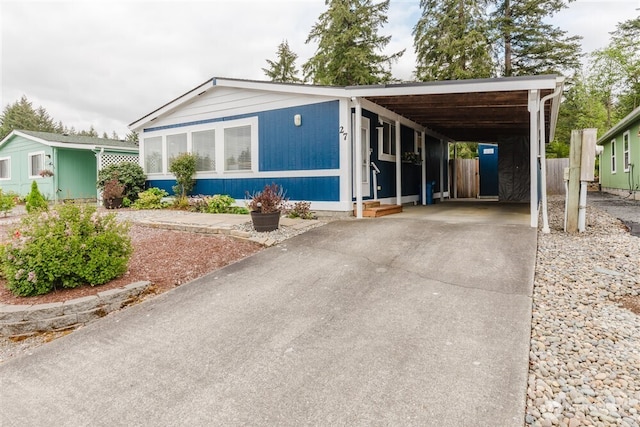 1101 S Scheuber Rd # 27, Centralia, WA 98531 - manufactured / mobile home with driveway, a carport, fence, and entry steps