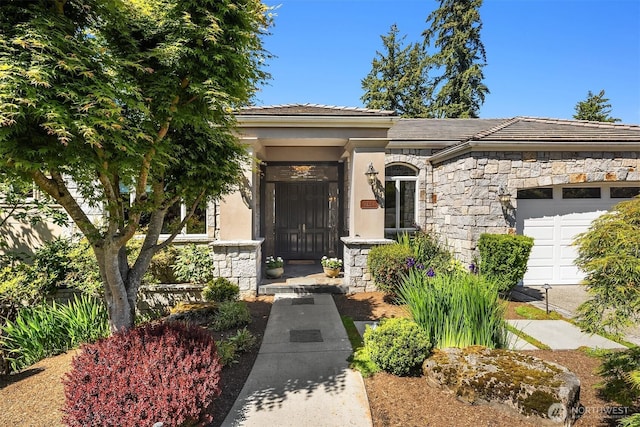 9234 NE 25th St, Clyde Hill, WA 98004 - doorway to property with stone siding, an attached garage, a tiled roof, and stucco siding