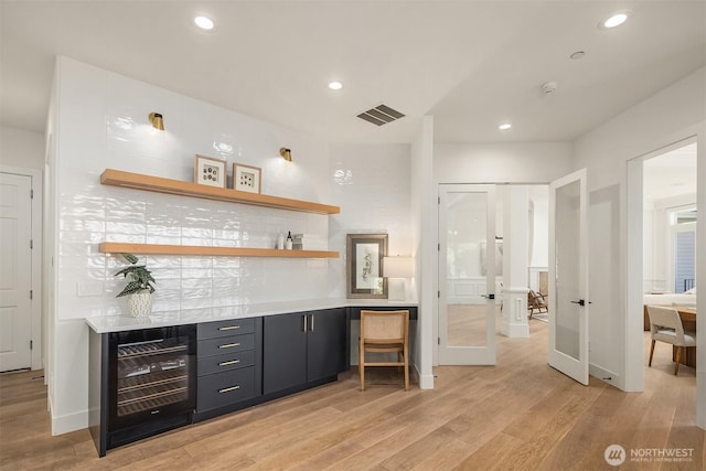 9234 NE 25th St, Clyde Hill, WA 98004 - indoor dry bar with wine cooler, light wood-type flooring, recessed lighting, and baseboards