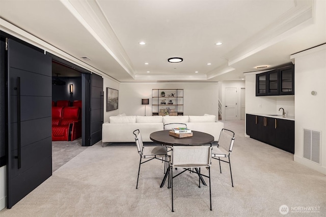 9234 NE 25th St, Clyde Hill, WA 98004 - dining space with a tray ceiling, bar with sink, light colored carpet, recessed lighting, and ornamental molding