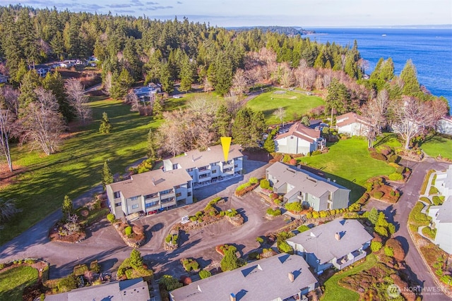 aerial view of property's location with a nearby body of water and nearby suburban area