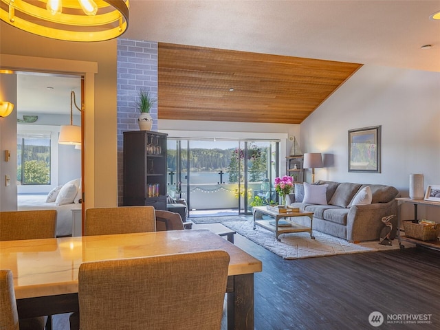 living room with lofted ceiling, plenty of natural light, and wood finished floors