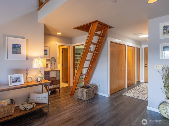 foyer entrance featuring wood finished floors, stairs, baseboards, and recessed lighting