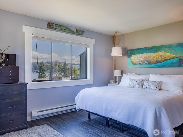 bedroom with baseboard heating and dark wood-style floors