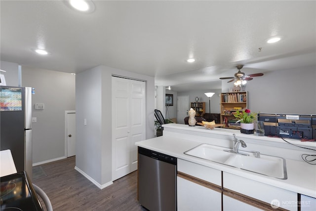 701 5th Ave S Unit C105, Kent, WA 98032 - kitchen featuring stainless steel appliances, a sink, recessed lighting, light countertops, and dark wood finished floors