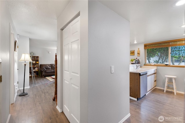 701 5th Ave S Unit C105, Kent, WA 98032 - corridor featuring light wood finished floors, baseboards, and a sink