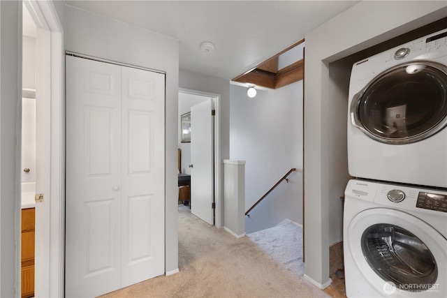 701 5th Ave S Unit C105, Kent, WA 98032 - clothes washing area featuring stacked washer and clothes dryer, light colored carpet, and baseboards