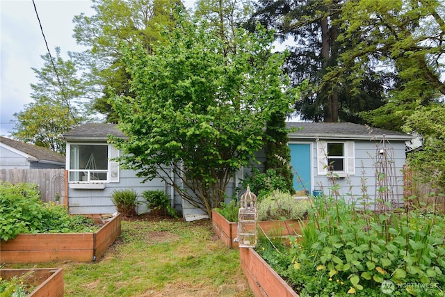 1917 NE 143rd St, Seattle, WA 98125 - view of front of house featuring a garden, fence, and a shingled roof