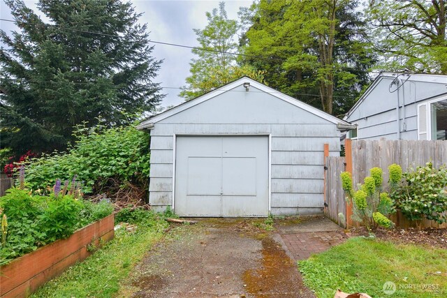 1917 NE 143rd St, Seattle, WA 98125 - garage featuring fence and a storage unit