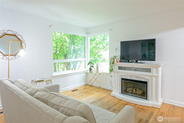 1917 NE 143rd St, Seattle, WA 98125 - living room featuring wood finished floors, plenty of natural light, and baseboards