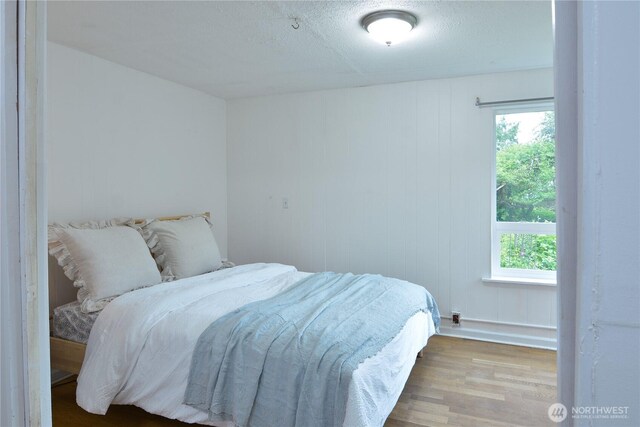 1917 NE 143rd St, Seattle, WA 98125 - bedroom with wood finished floors and a textured ceiling