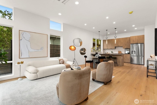 8333 14th Ave NW Unit A, Seattle, WA 98117 - living area with recessed lighting, healthy amount of natural light, light wood-style floors, and baseboards