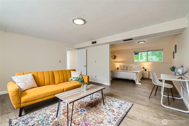 living room featuring wood finished floors and baseboards