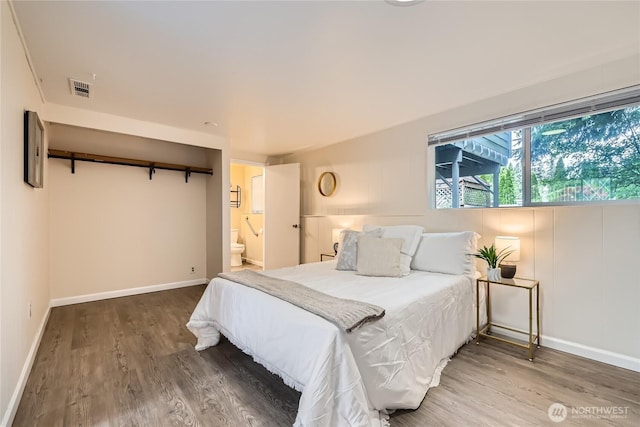 bedroom with wood finished floors and baseboards