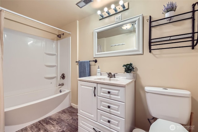 bathroom featuring toilet, vanity, and washtub / shower combination
