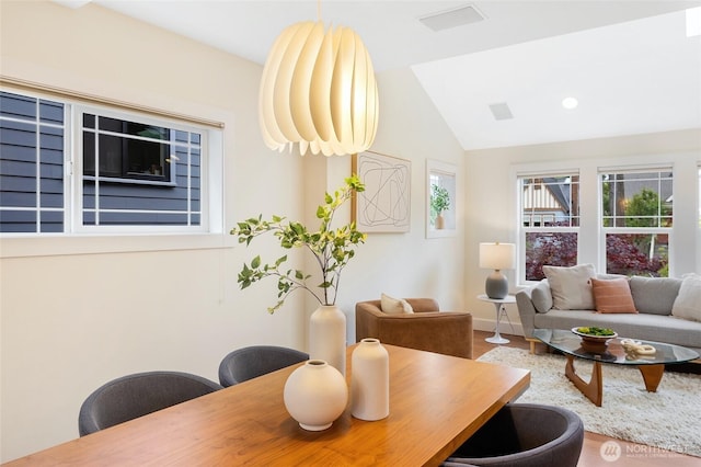 dining space with vaulted ceiling