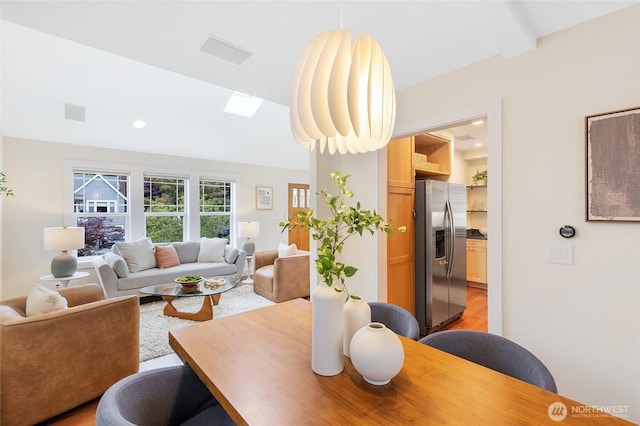 dining room featuring light wood-style flooring, a skylight, and recessed lighting