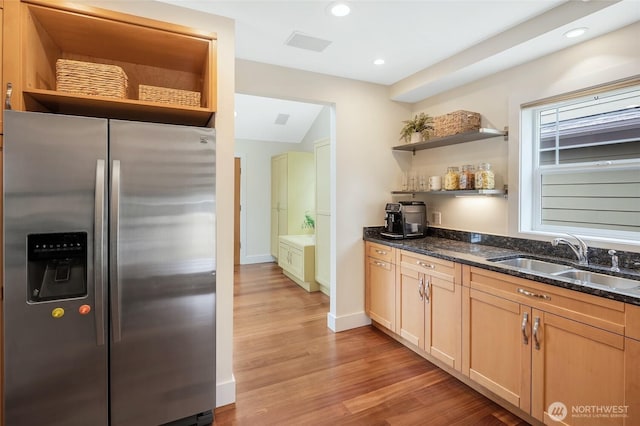 kitchen with stainless steel fridge with ice dispenser, open shelves, a sink, dark stone countertops, and recessed lighting