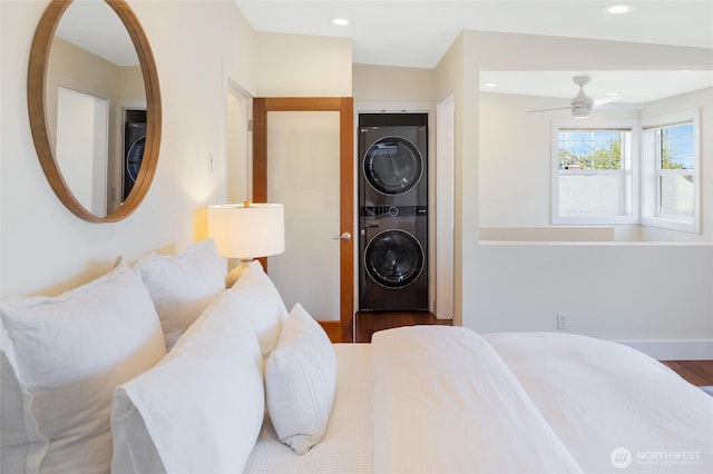 bedroom featuring stacked washer / drying machine, wood finished floors, and recessed lighting