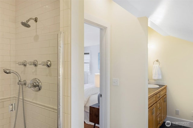 ensuite bathroom with a stall shower and vanity