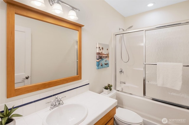full bathroom featuring toilet, vanity, backsplash, shower / bath combination with glass door, and recessed lighting