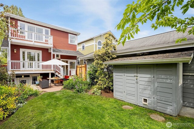 rear view of house featuring a yard and a patio area
